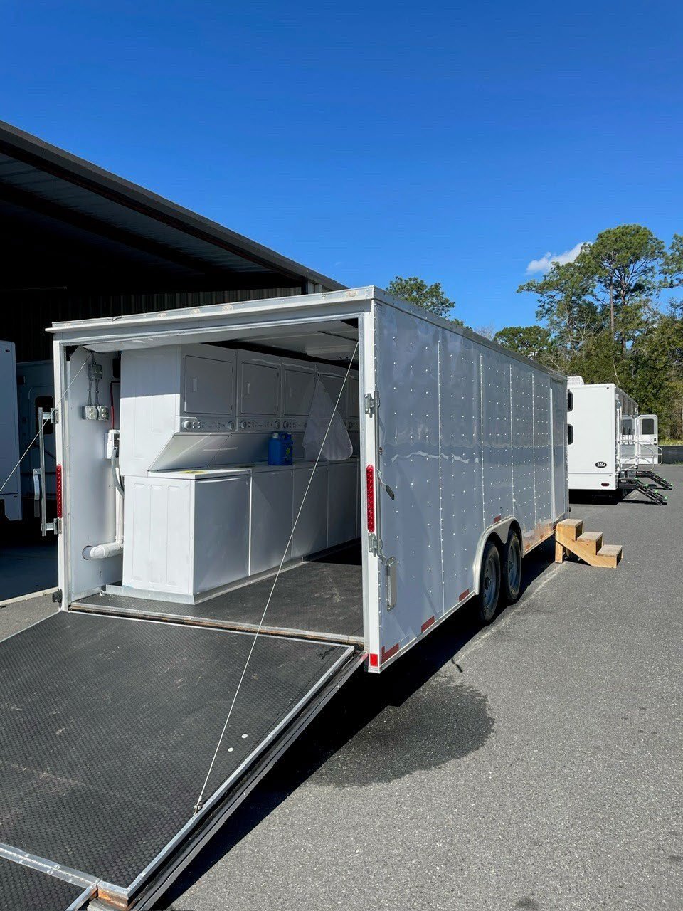 Mobile laundry trailer with equipment set up.