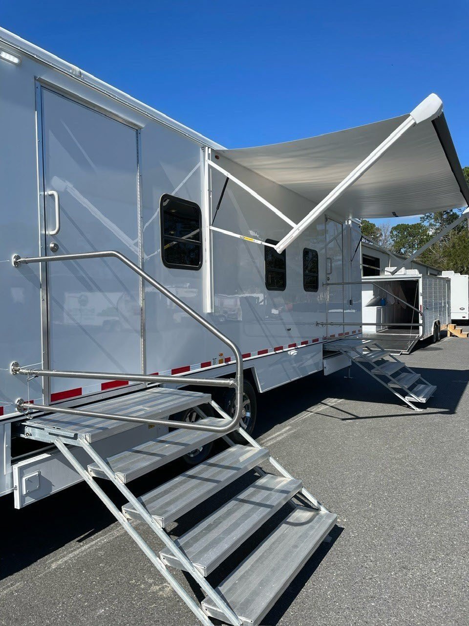 Shower and restroom trailer with awning deployed.