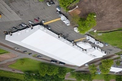 Aerial view of a long tent structure supporting a base camp event.